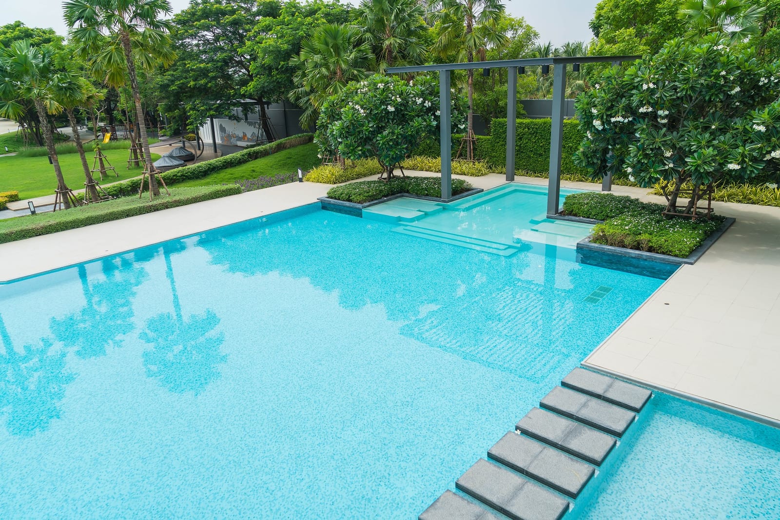 Clear-water inground pool set into a landscaped backyard